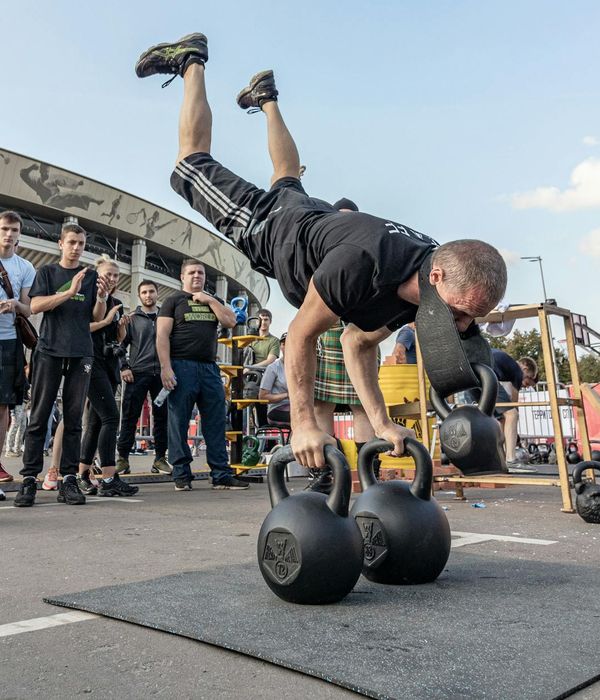 Man performing balanced physical exercises in a gym setting