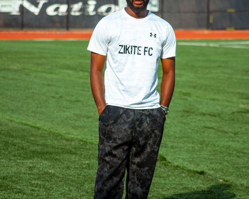 Man standing confidently in sports attire