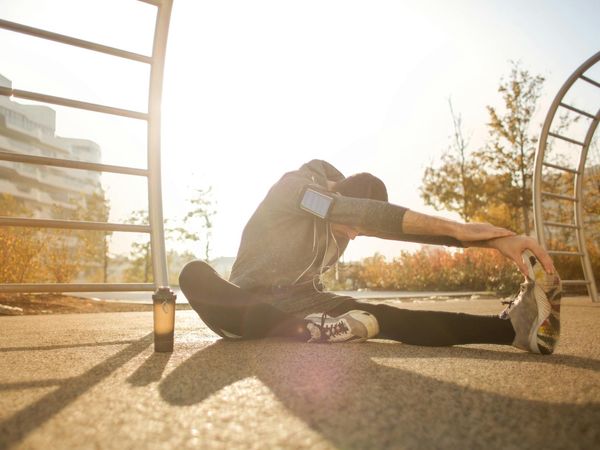 Man stretching comfortably at sunrise